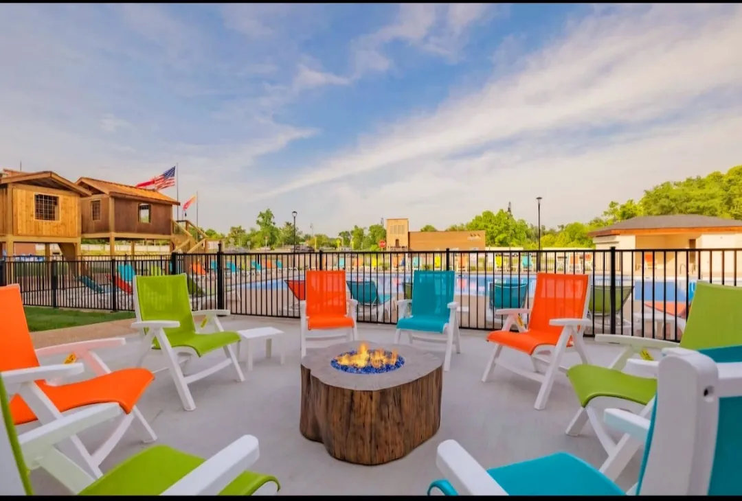 Fire pit located next to outdoor pool